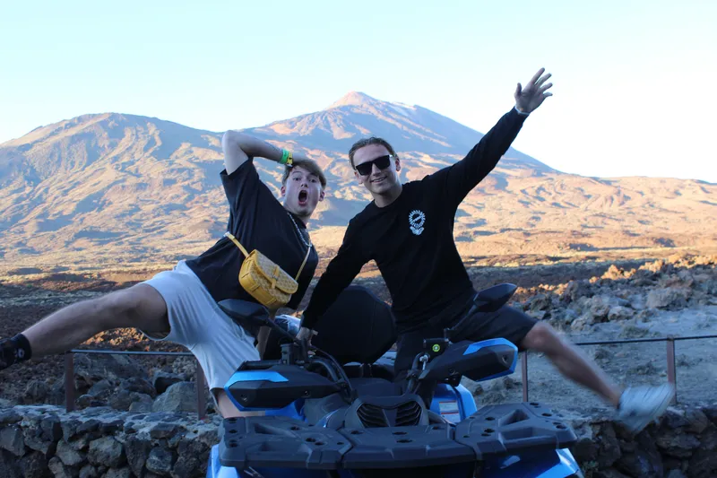 Sunset silhouettes of quad bikes and riders above the clouds in Tenerife